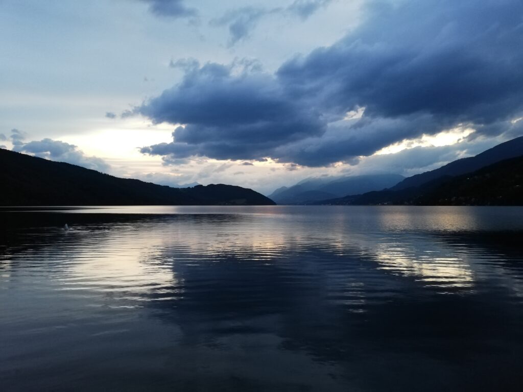 Ein See in Morgenstimmung, über dem Wolken aufziehen